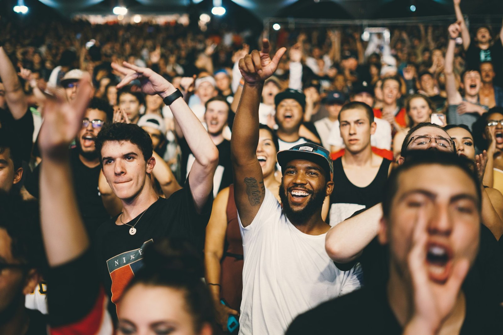 Artist performing in front of a massive concert crowd
